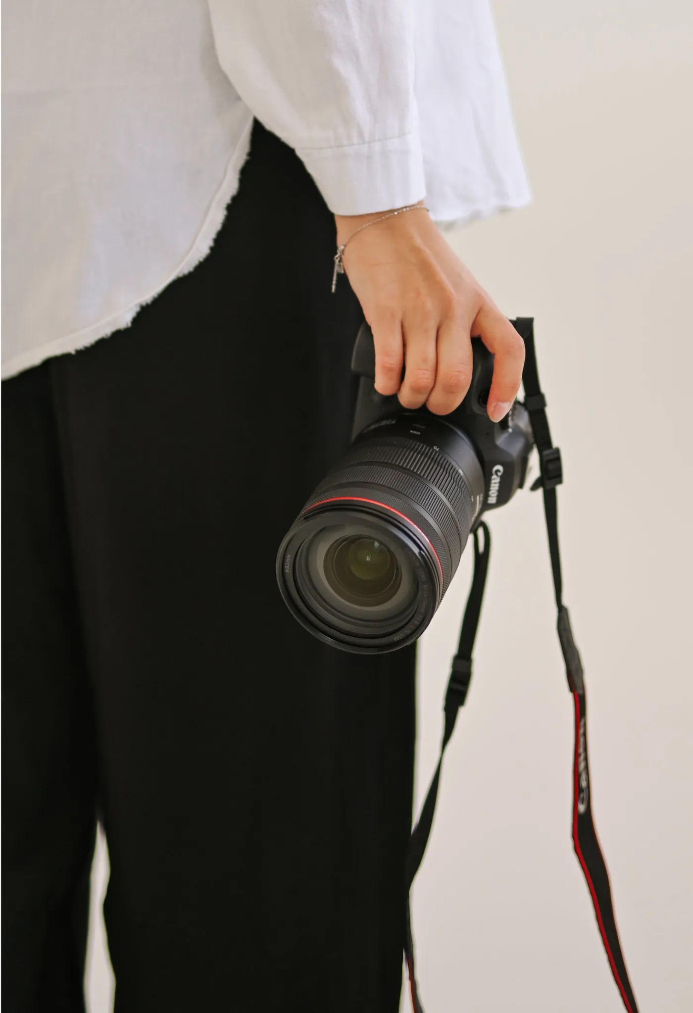 Lena&rsquo;s hand holding her camera by its grip